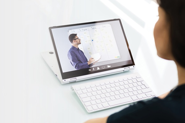 Woman watching a presentation on a laptop