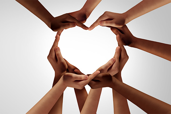 The IDEA (Inclusion, Diversity, Equity & Advocacy) A gathering of hands of different skin tones that form the shape of a heart